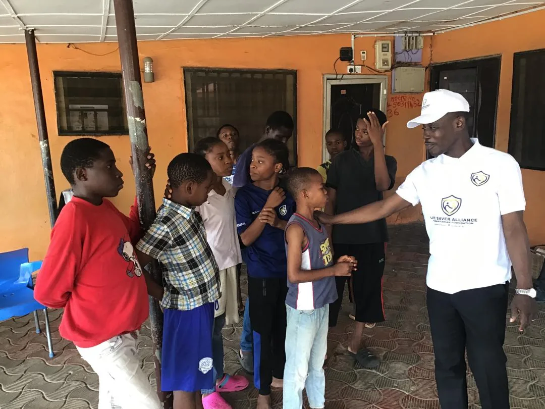 Children greet and gather around LAHF volunteers at City of Refuge Orphanage
