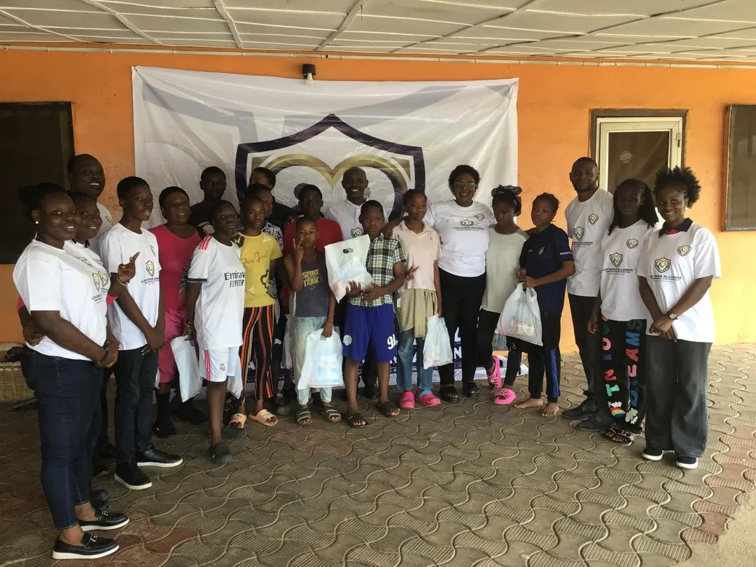 Children and LAHF volunteers gather for a group portrait at City of Refuge Orphanage