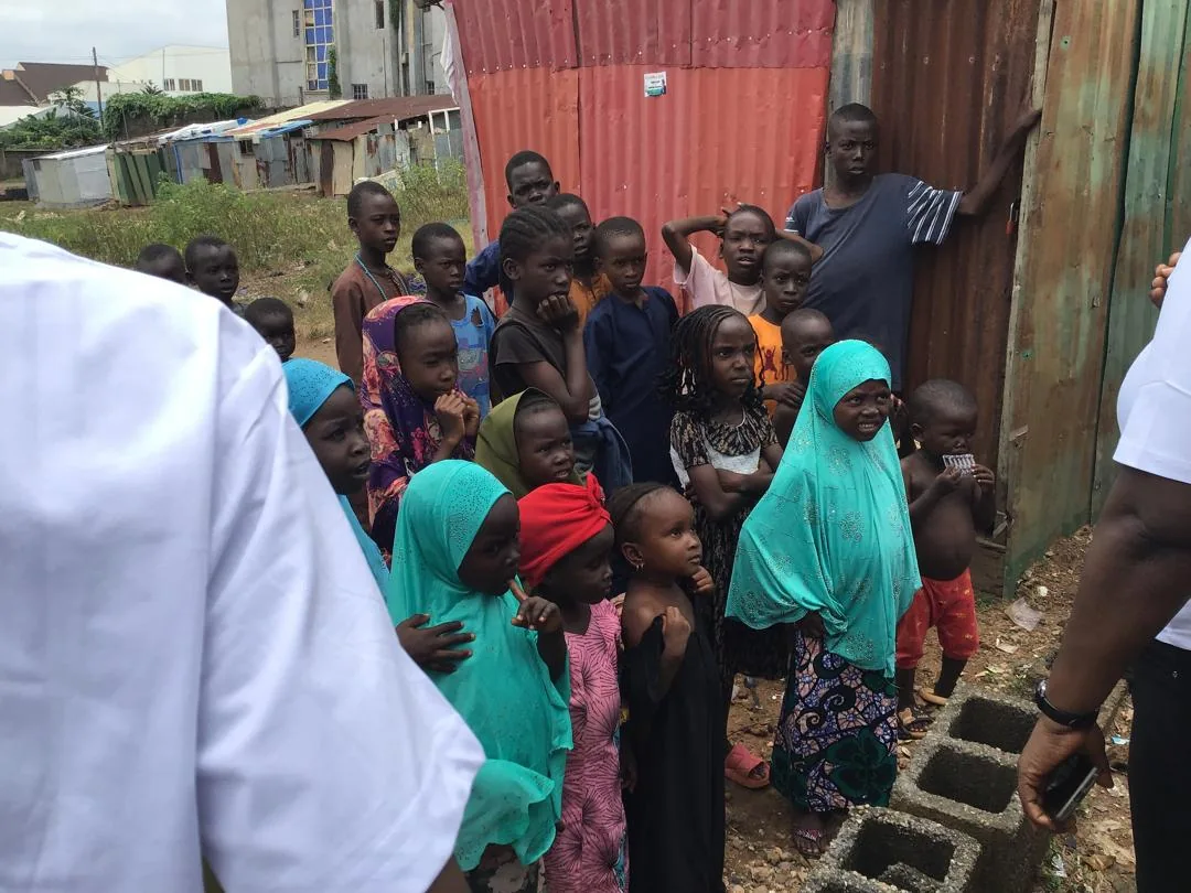 Children listen together between the shelters during LAHF’s Crown Court Estate visit