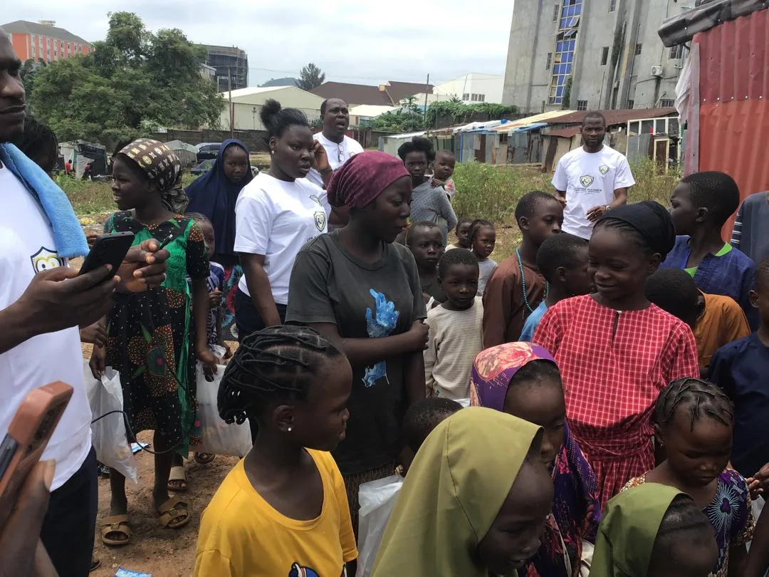 LAHF volunteers stand among children and families during the outreach